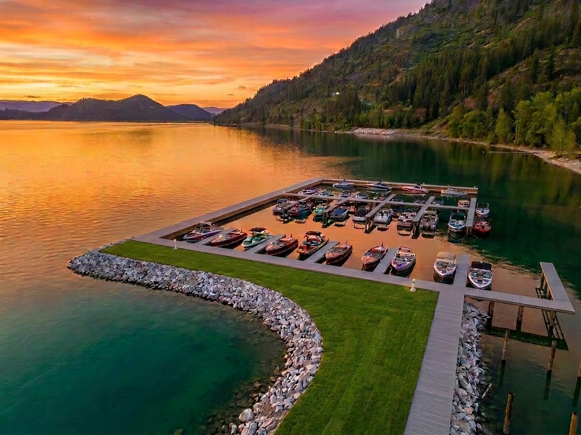 Idaho Club marina at twilight with luxury dock slips on a still lake surrounded by pine-covered mountains